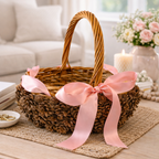 Pinecone basket with pink ribbon handmade by Ausable wreath company on a table as a table decor surrounded by florals