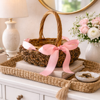 Pinecone basket with pink ribbon handmade by Ausable wreath company on a table as a table decor