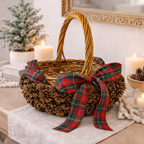 Pinecone basket with plaid ribbon handmade by Ausable wreath company on a table as a table decor 